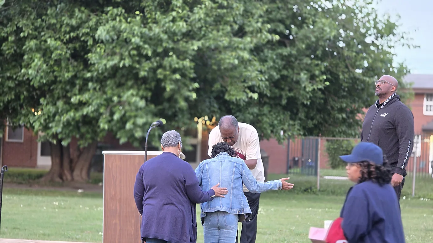 People receiving prayer during an outdoor outreach
